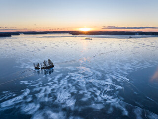 sunset on the icy lake in winter