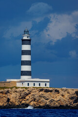 Vertical view of a lighthouse with clouds in the sky
Isla del Aire