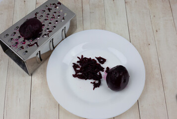 Grate beets on a grater. Grated beets. Grate the beetroot on the grater