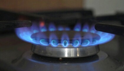 Close-up of a gas stove burner with blue flames