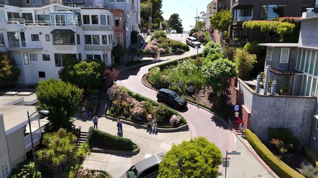 Aerial view of Lombard Street&rsquo;s famous crooked block in San Francisco, showcasing its eight sharp hairpin turns winding steeply through Russian Hill, a top tourist attraction.