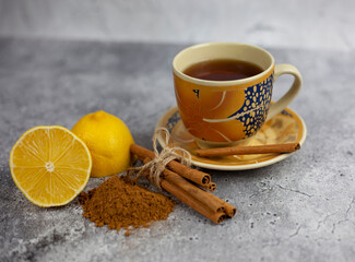 hot ginger tea with lemon and cinnamon. flu cold season drink.