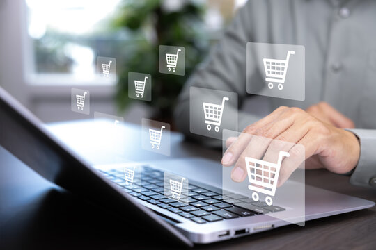 Businessman hold smartphone with online shopping concept, marketplace website with virtual interface of online Shopping cart part of the network, Online shopping business with selecting shopping cart.