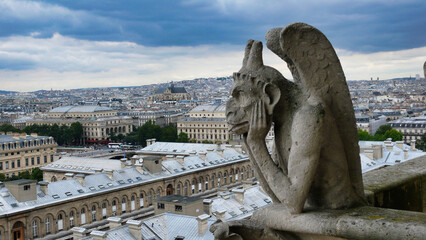 Gargoyles of Notre Dame overlooking Paris: The iconic gargoyles of Notre Dame Cathedral gaze out...