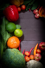 Fresh organic fruits and vegetables on wooden background