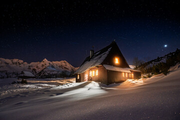Snowy Mountain Cabin at Night