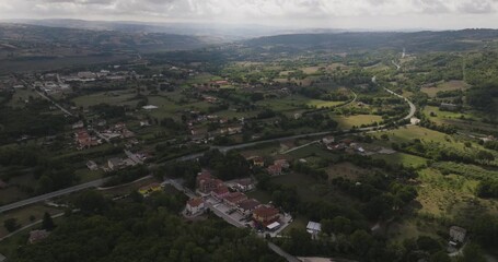 Aerial view of the landscape showing houses, roads, and greenery, a scenic blend of rural and residential areas, Morcone, Campania, Italy.