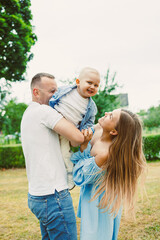 A Joyful Family Moment in Nature Loving Parents Engaging and Playing with Their Adorable Baby in...