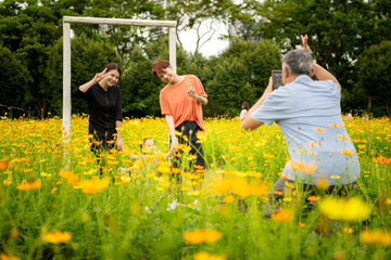 Asian family stroll through a large flower garden in a large flower garden in the middle of the city