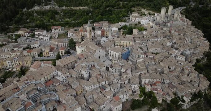 Aerial view of the ancient town of Pacentro with its medieval towers and clustered buildings creating a dense, textured landscape, Pacentro, Abruzzo, Italy.