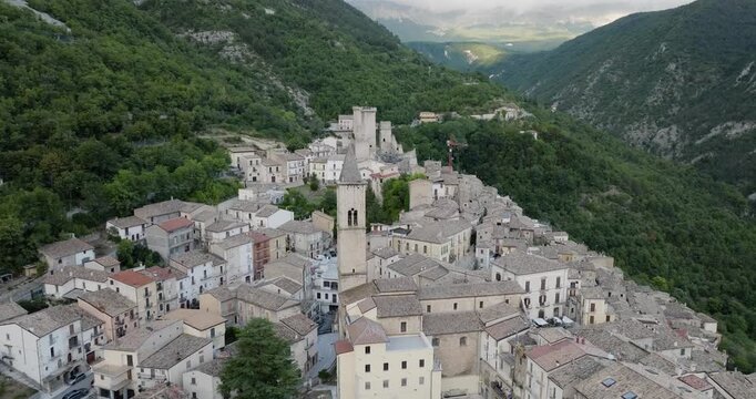 Aerial view of the ancient town of Pacentro, Italy, with its historic castle perched atop a hill, surrounded by lush green mountains, Pacentro, Abruzzo, Italy.