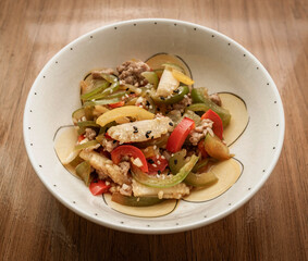 Stir-fried sweet peppers, baby corn, and minced pork topped with black and white sesame seeds.