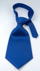 A close-up view of a richly colored, textured tie, knotted and presented against a bright background.
