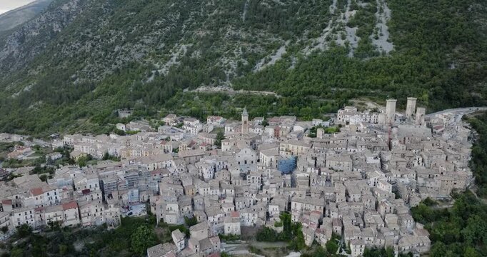 Aerial view of the town of Pacentro nestled against the backdrop of majestic mountains, a timeless tapestry of stone buildings and lush greenery, Pacentro, Abruzzo, Italy.