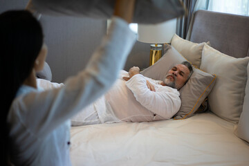 Couple is fighting in bedroom.