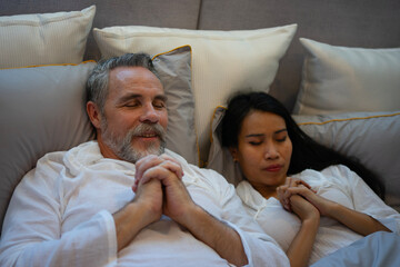 Couple is sleeping at bedroom.