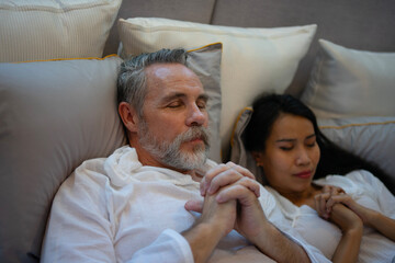 Couple is sleeping at bedroom.
