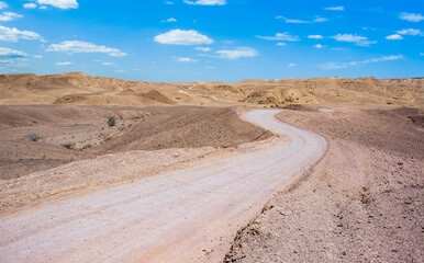 desert dunes sand stone landscape dry wasteland south scenic view with driving path way to horizon line