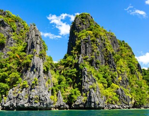 Dramatic limestone cliffs rise from turquoise water, lush vegetation clinging to the rock face under a vibrant blue sky