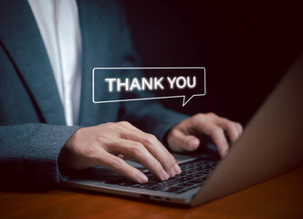 Businessman typing on laptop with thank you text message speech bubble, symbolizing online communication, customer support, gratitude, email marketing, and professional business concept.