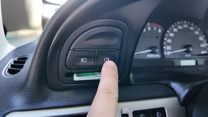 analog car buttons. Man finger pressing play button on vintage tape player. close up finger pressing off button on car climate control panel to disable ac while illuminated recirculation