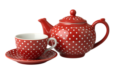 A charming vintage red ceramic teapot with white polka dots and a matching teacup and saucer presented isolated on transparent background