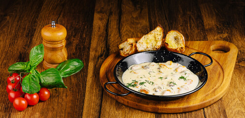 Delicious creamy mussels dish served with fresh herbs and bread