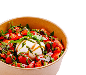 Fresh salad with mozzarella, tomatoes, and basil in a bowl