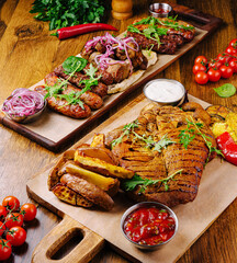 Delicious grilled meats served with fresh vegetables on wooden table