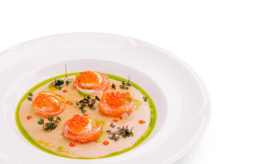 Elegant dish featuring salmon roses with vibrant sauce and garnishes