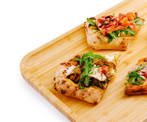 Delicious flatbreads topped with fresh ingredients on a wooden board