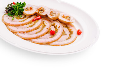 Sliced meat roll served on a white platter with herbs and chili