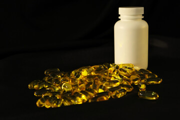 Omega3 gel capsules on black background. Soft Fish Oil Capsules. Floating fatty acids softgel...
