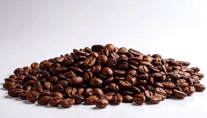Roasted coffee beans piled high on white background