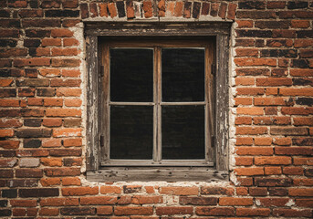 Rustic brick wall with old window offering a moody vintage architectural design
