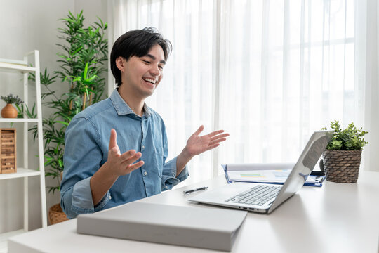 Asian young handsome man making a remote virtual video call in house. 