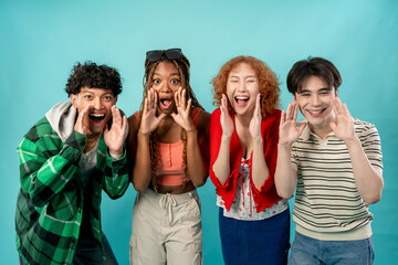Portrait of diverse Generation Z friends posing on isolated blue screen. 