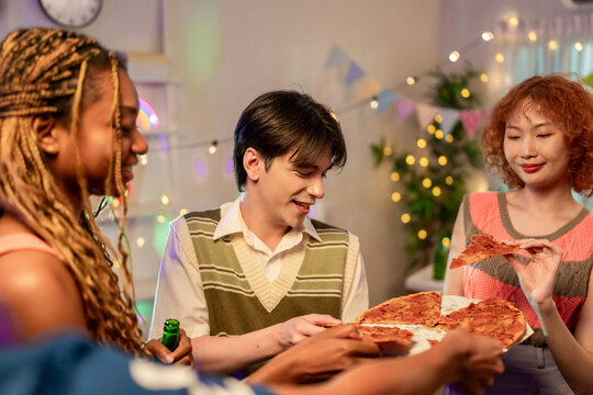 Group of diverse Generation Z friends enjoying a party in cozy house.  - Powered by Adobe