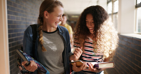 Friends, walking and girls at high school in hallway for learning, lesson and education together. Happy, campus and teenagers in conversation, talking and chat in corridor for bonding, relax or break