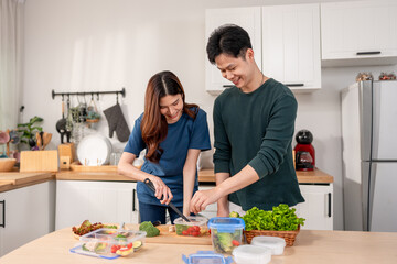 Asian young new marriage couple spend time together in kitchen at home. 