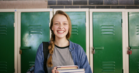 Books, happy and portrait of girl in high school for education, scholarship and gcse classes. Gen z student, yearbook and project study with teenager in hallway of campus for textbook assessment