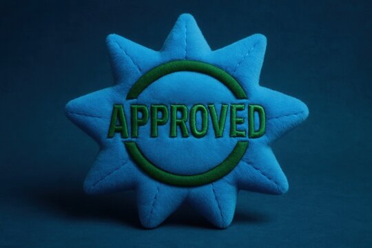 Soft plush APPROVED seal with simple design, vibrant color, and a bold retail endorsement display for promotional use.