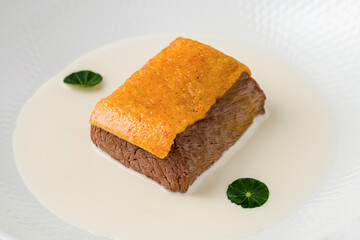 Gourmet beef served with creamy white sauce and crispy topping
