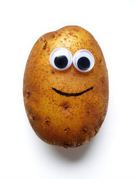 Naklejki Funny potato with googly eyes and a smile isolated on white background