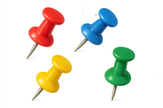Multicolored push pins scattered on clear surface, representing organizing supplies with vibrant office accessory design