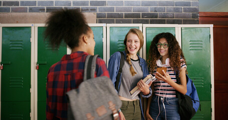 High school, group and friends talk in hallway for education, funny meme and scholarship. Phone, students and teen girls learning with app for joke, game or laugh with chat for curriculum online