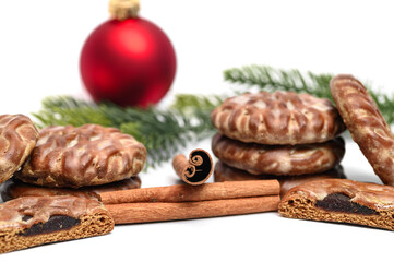 Christmas-themed background, bauble, pine needles, cinnamon and glazed gingerbread cookies