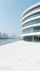 Fototapeta premium Modern Curved Building with Reflective Glass Facade Near Waterfront