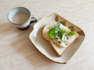 Chicken breast and spinach open sandwich with milk coffee 