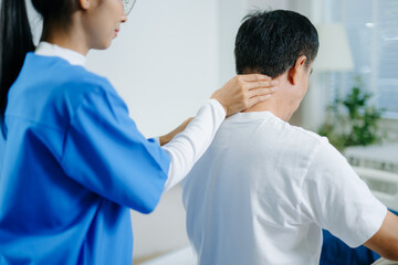 Fototapeta premium Healthcare professional assists senior man with shoulder stretch therapy. Ideal for rehab, physiotherapy, aging wellness, pain treatment, and medical care concepts.